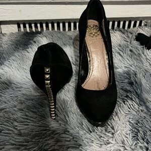 Black heels with a gold design on the heel